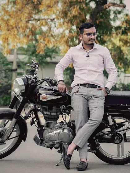A classic pose with a Royal Enfield motorcycle. These bikes add a cool, timeless vibe to outdoor and pre-wedding photography sessions.
