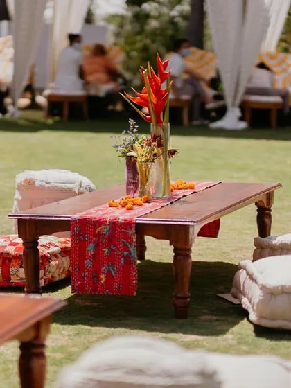 Low seating with colorful kantha-work runners and floor cushions at our 'Rajasthani Folklore' Mehendi, creating a relaxed and traditional 'baithak' style lounge.