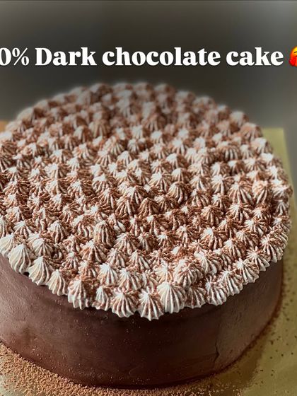 An intense 70% Dark Chocolate cake for the true connoisseur. The beautiful piping on top adds an elegant finish to this deeply flavorful cake.