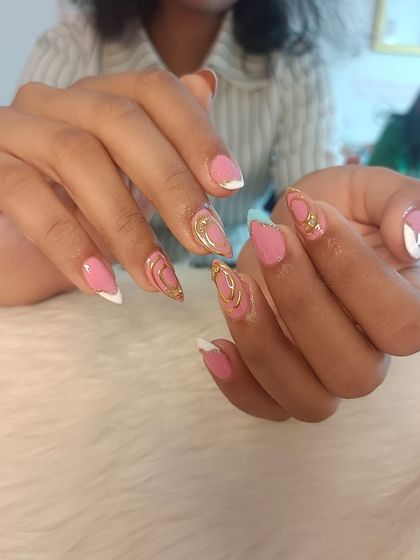 A recap of a week's work, featuring a pink and white set with delicate gold chrome swirls.