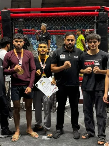Our coaches and fighters celebrating their wins, holding medals and certificates as proof of their hard work.