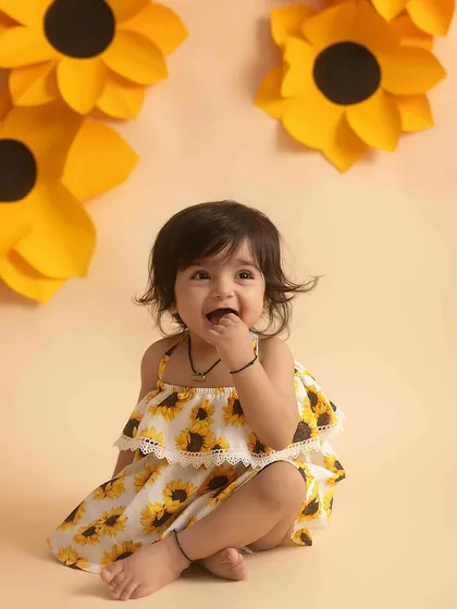 Giggles and grins! This candid shot perfectly captures the joy of a toddler photoshoot.