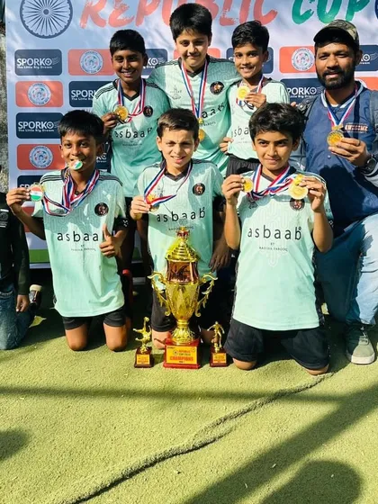The champion U11 team and their coach posing with the Republic Cup 2024 trophy. Hard work pays off.