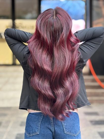 The back view of the global plum red hair, showcasing the long, luscious waves and deep color.