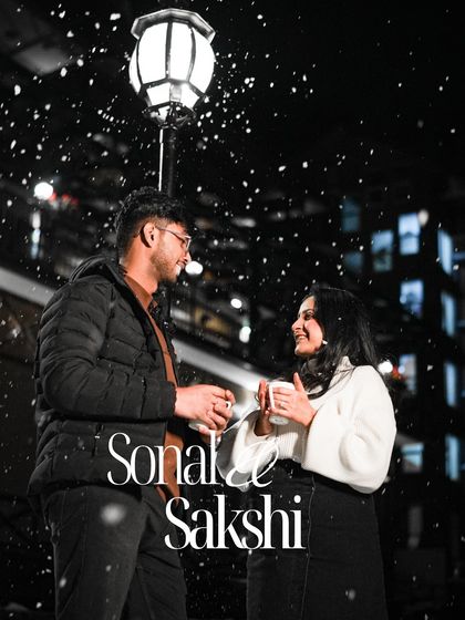 A beautifully edited photo of a couple under a lamppost in the falling snow, creating a perfect movie-like moment.