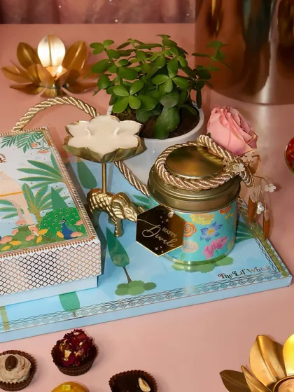 Gifting is our love language. Our Gardenia Platter combines our artisanal sweets with thoughtful keepsakes like a live jade plant and a beautiful candle, creating a luxurious and memorable gift for any festival or celebration.
