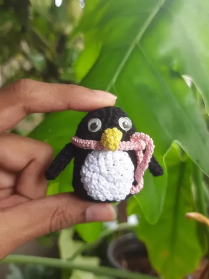 This little penguin is all bundled up in a pink scarf. It's a perfect winter-themed desk buddy or keychain, and the googly eyes give it so much character.