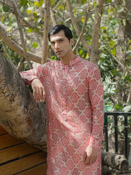 A brighter, pink-toned printed kurta that is perfect for daytime events. The geometric pattern is both traditional and modern, offering wide appeal.