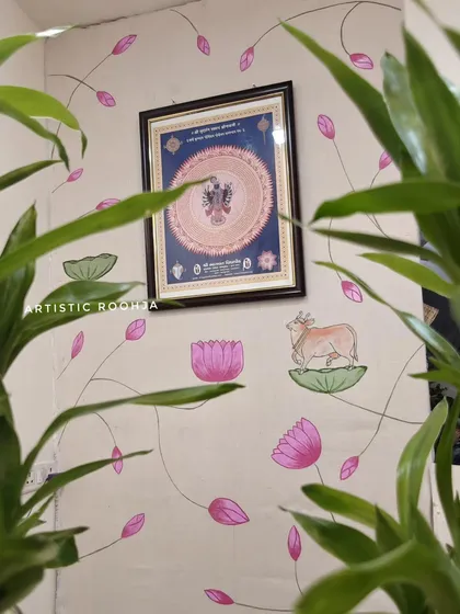 A view of the flower shop's Pichwai mural, framed by indoor plants, which enhances the natural theme of the artwork.