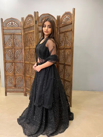 A full-length view of the black lehenga, showing its graceful A-line cut.