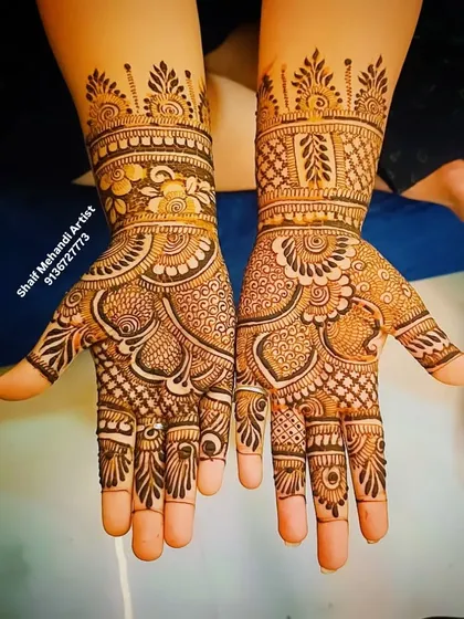 A classic Indian mehandi design with full palm coverage, featuring floral and paisley elements.