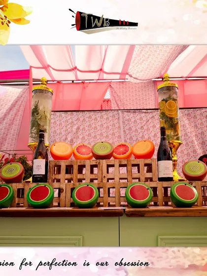 A colorful bar setup with fresh fruit displays for a sunny Mehendi brunch.