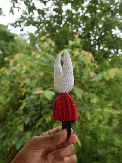 A back view of the Hornet doll, highlighting the clean stitch work on the head and the shape of the cloak. Every detail is handcrafted with care.