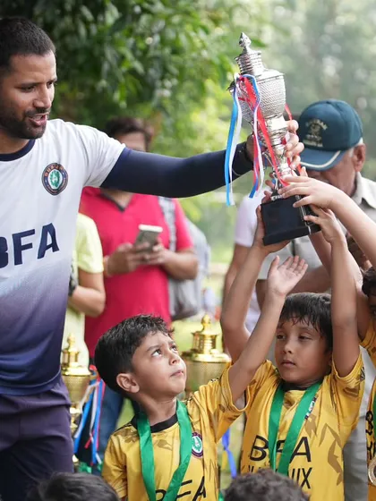 Presenting the trophy to these deserving young champions. It is a privilege to guide them on their football journey.