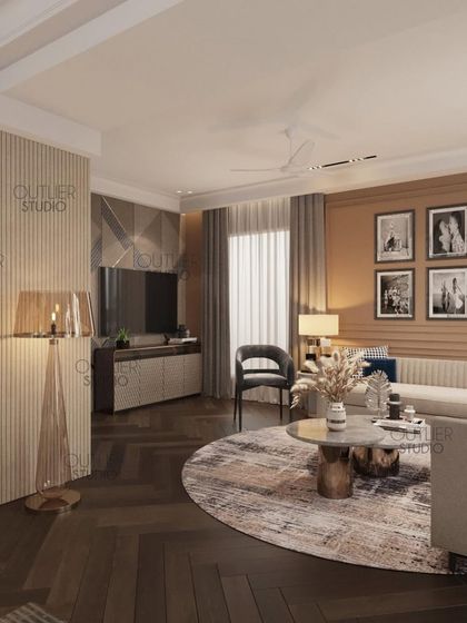 Another angle of the luxurious master suite, showing the comfortable seating area with a round rug and a gallery wall of personal photos, making the space feel both elegant and personal.