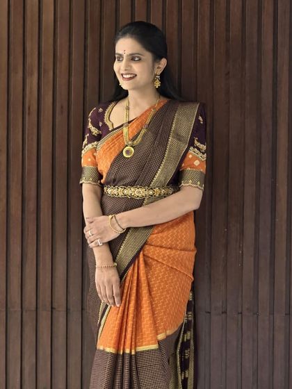 A happy client flaunting her pure Mysore crepe silk saree. The rich orange and brown combination with a traditional border looks absolutely stunning on her.