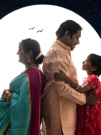 A unique family silhouette pose against a starry night backdrop. This creative composition tells a story of connection and anticipation.