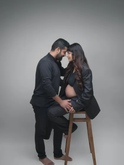 A modern, minimalist portrait that is both strong and intimate. Dressed in all black, their forms create a beautiful composition. The focus is on their quiet connection and the anticipation of their new life together.