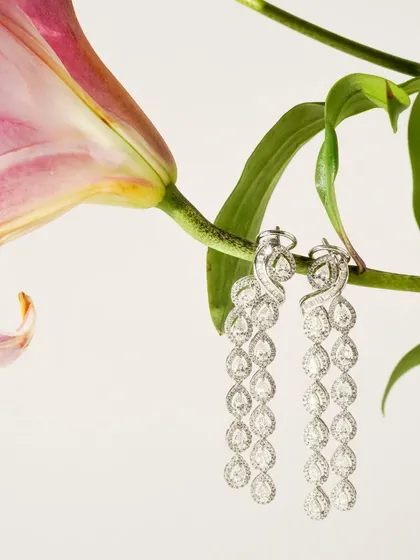 A duplicate of image 76, this shot features stunning diamond earrings hanging from a flower. The composition is a perfect example of how we blend nature and luxury in our jewellery photography.