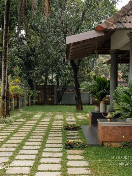 The landscaped garden uses stone pavers and lush grass to create a beautiful and functional outdoor space that complements the traditional architecture.