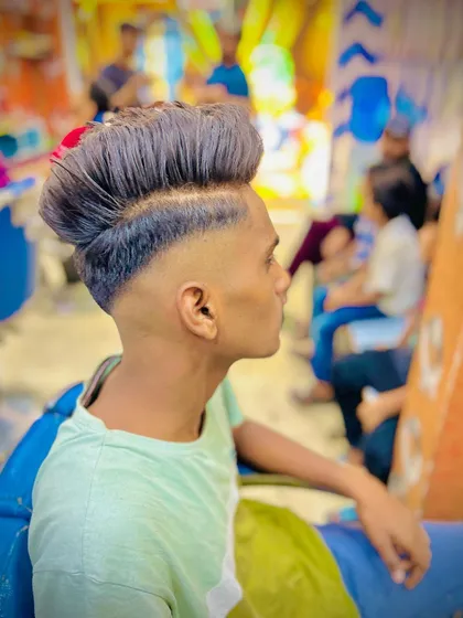 A high skin fade with a textured pompadour is a classic for a reason. This style is all about clean lines and impressive volume, creating a sharp and confident profile.