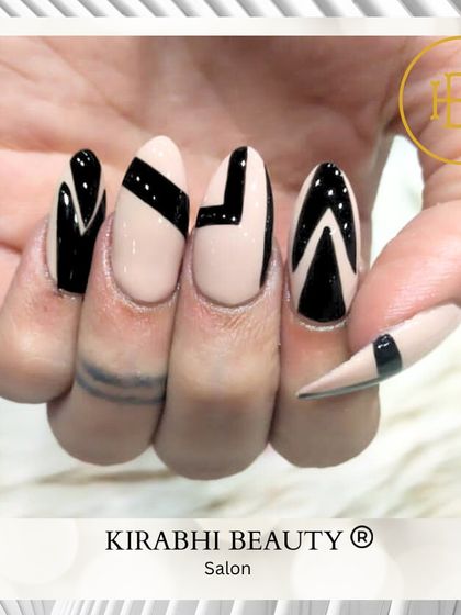 Bold, graphic, and modern. This nail art features strong black geometric shapes and lines on a nude base for a high-contrast, minimalist design.