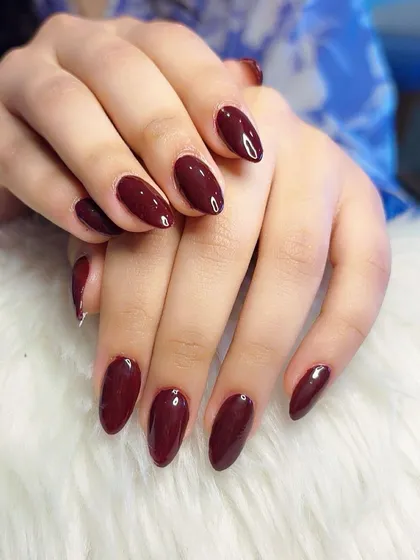 The perfect glossy finish on these deep red nails.