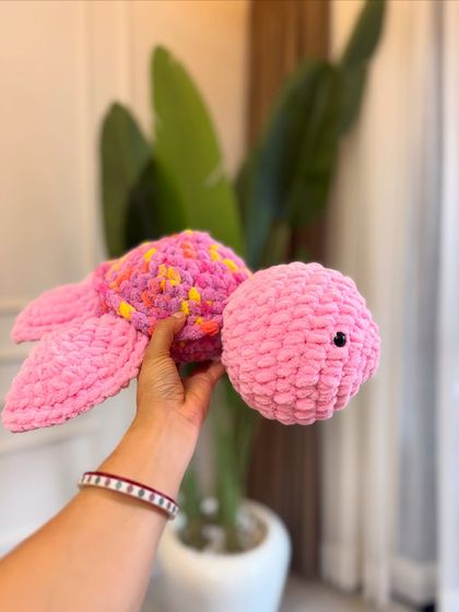 This pink sea turtle plush is ready for a cuddle. The simple, embroidered eyes make it safe for even the youngest babies.