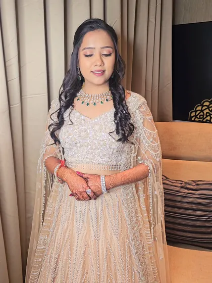 A full-length view of her elegant Sangeet lehenga. The makeup was designed to complement the sparkling outfit without overpowering it.