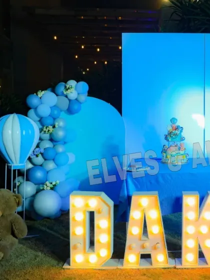 An angled view of the stage, showing the hot air balloon prop and marquee letters.