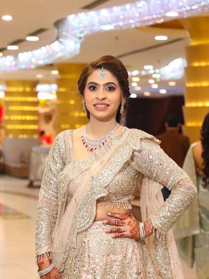 From our client diaries. A happy customer looking elegant in a fully sequined silver lehenga at her event.