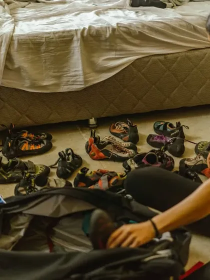 A volunteer organizes our extensive collection of climbing shoes. Thanks to our partners, we can outfit many new climbers with the gear they need.