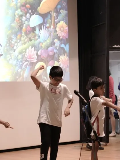 A high-energy moment from a 'Mission Unstoppable' rehearsal, demonstrating physical acting and teamwork as the children create a dynamic scene together.