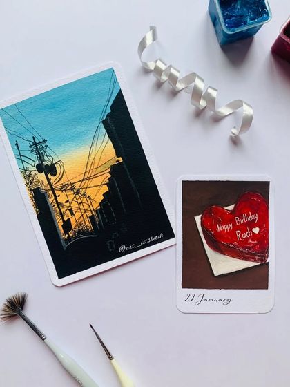 More amazing art from my artist friends in our group collaboration, featuring a cityscape and a heart-shaped cake.