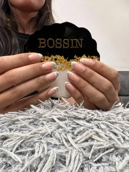 I elevated this classic French manicure by adding a touch of glamour. A delicate layer of gold foil is applied at the tip, creating a beautiful contrast with the clean white line.