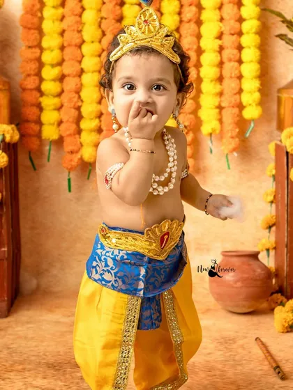 Caught in the act. This adorable little Krishna is captured with a hand in the butter, a classic and cute pose for our Janmashtami mini-sessions.