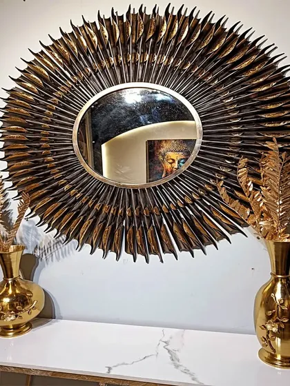Make a bold statement with this premium sunburst metal wall mirror. The intricate, layered design in an antique finish creates a spectacular play of light and shadow, turning a simple mirror into a grand piece of wall art that expands and brightens your space.