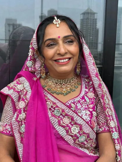 It was so special to get my mother-in-law ready for Mahavir Janamvanchan. I gave her a dewy, celebratory look with a traditional pink outfit that made her smile shine.