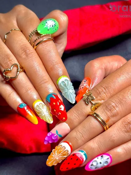 Nail art is a detailed craft, and we teach it all. This set of 3D fruit-themed nail extensions showcases the intricate sculpting and painting techniques our students master in our nail artistry program.