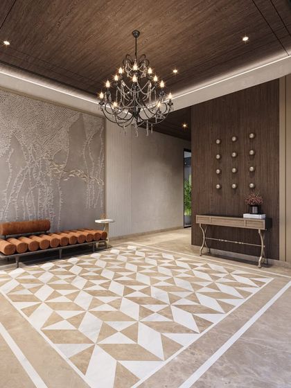 The entrance foyer concept for a modern-classic villa, featuring a bold geometric floor pattern, a large-scale textured art piece, and an elegant daybed.