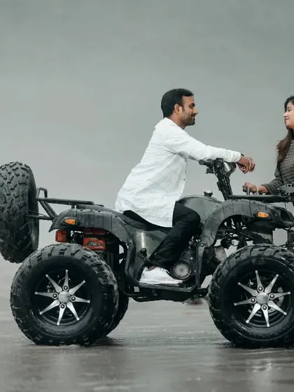 A candid and happy moment during an ATV shoot. The couple's interaction with the vehicle adds a fun and dynamic element to their photos.