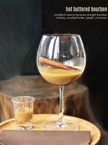 Hot Buttered Bourbon, the ultimate comfort cocktail. Woodford Reserve bourbon is mixed with unsalted butter, peepli, and cinnamon for a warm, rich, and spiced drink.
