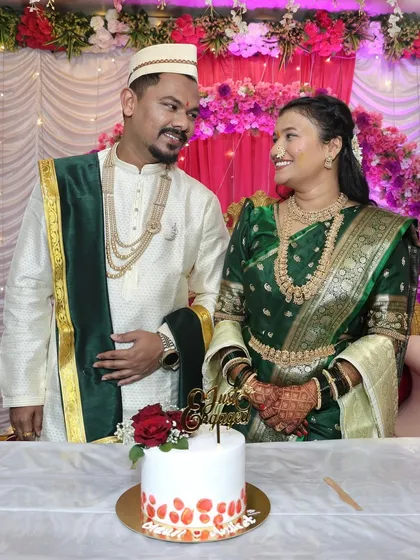 The look of love. This couple shares a smile during their engagement celebration, with our simple and elegant floral cake ready for the ceremony.
