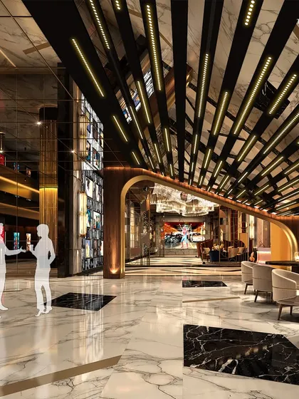 A view of the grand cinema lobby, where a dynamic ceiling installation and black and white marble floors create a sense of movement and drama. The design blends modern aesthetics with classic opulence for a truly memorable visit.