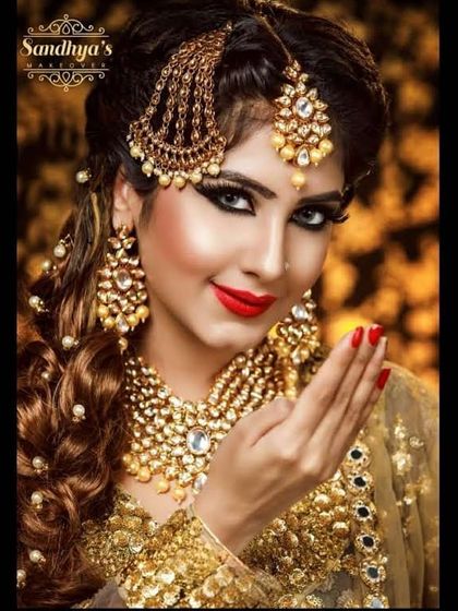 A truly royal look for rent. This all-gold ensemble, from the heavily embellished lehenga to the elaborate passa, maang tikka, and layered necklaces, is for the bride who wants maximum glamour.