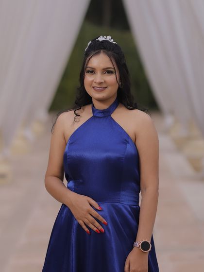 A smiling portrait of the client, ready for her event. The makeup is designed to be photogenic and long-lasting.