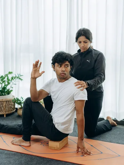 A block can be a powerful tool for teaching spinal twists. In this assisted Marichyasana, I am guiding the student to use the block for support, allowing for a deeper, more open twist without compromising the posture.