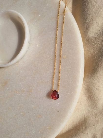 The 'ṣatra' Pink Tourmaline heart drop pendant, shown here in its minimalist beauty. This stone is perfect for anyone seeking to heal emotionally and open themselves to a more beautiful love life.