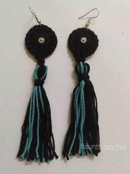 A pair of black and teal tassel earrings. These are a fun and stylish accessory that can be customized in a range of colors.