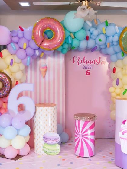 A sweet 6th birthday with a candy and donut theme, using pastel colors and a variety of dessert props.